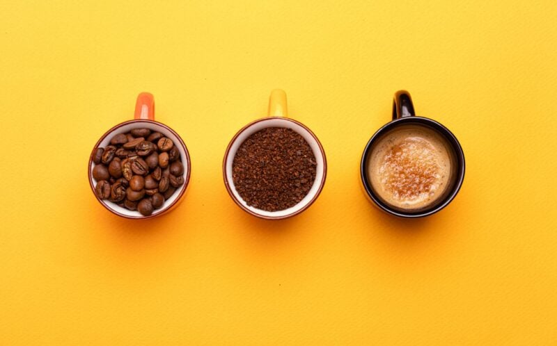 Três xícaras com café, grãos, pó e bebida pronta